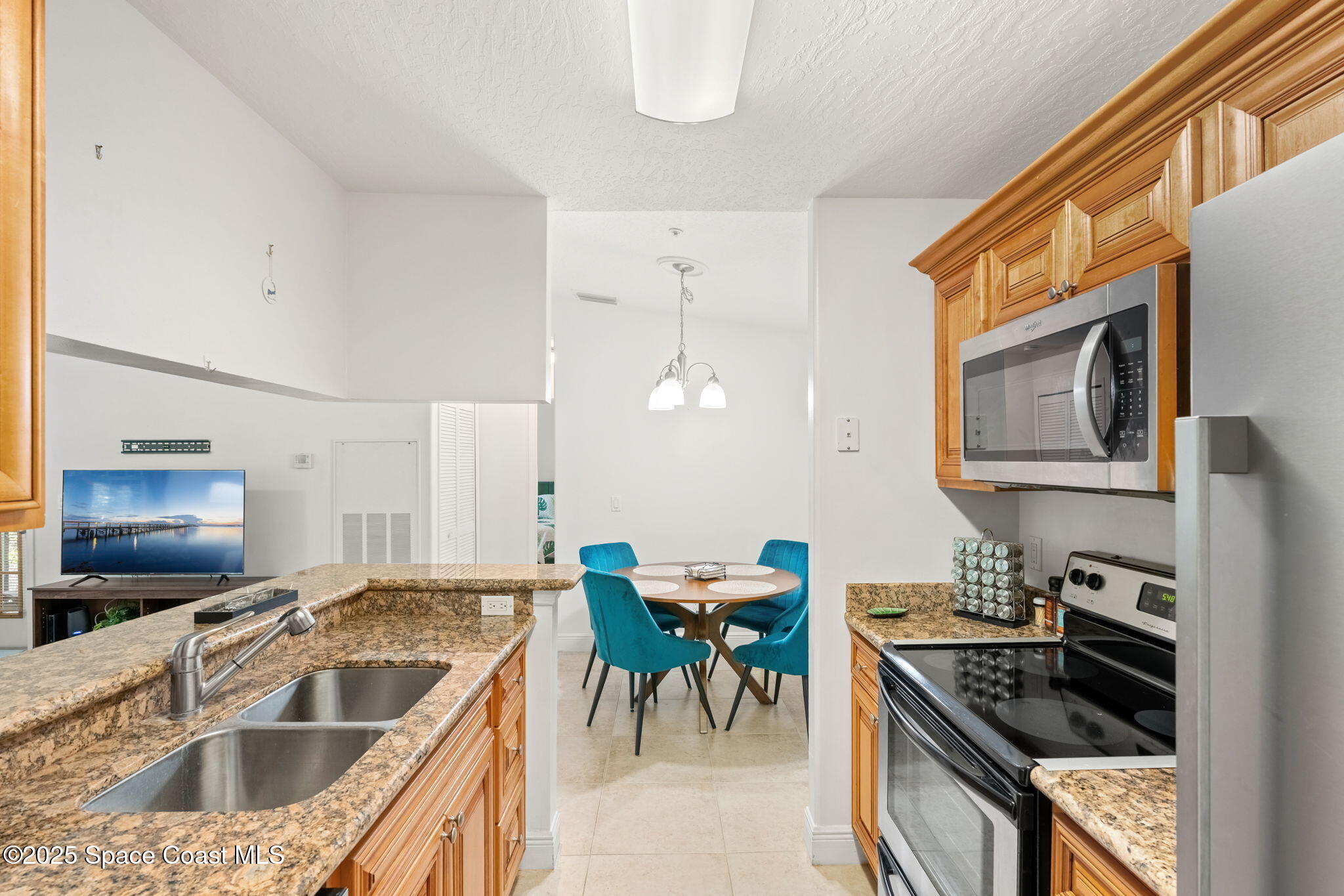 7667 North Wickham Road, Unit 518 Melbourne, FL 32940 - Photo 9 of 34 a kitchen with granite countertop a sink and a stove top oven