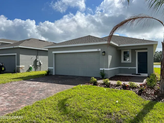 a front view of house with yard and outdoor seating
