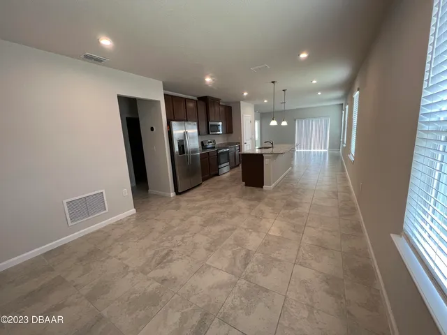 a view of kitchen with stainless steel appliances a refrigerator and a sink