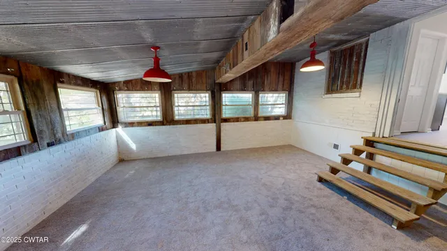 a room with stairs and a large window