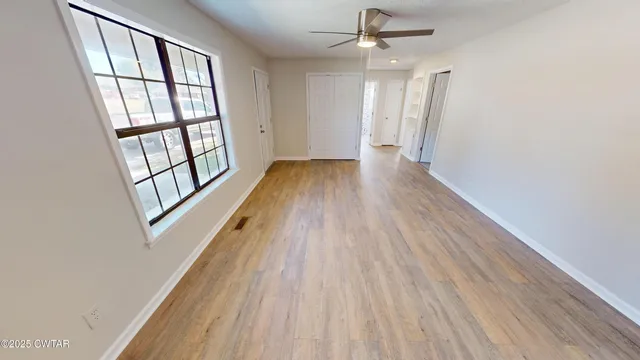 wooden floor in an empty room with a window