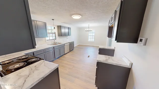 a kitchen with a stove and a sink