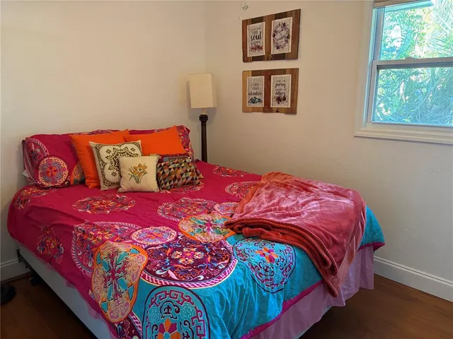 a bedroom with a bed and window