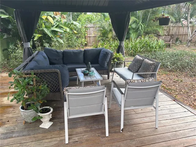 a view of a chairs and table in the back yard
