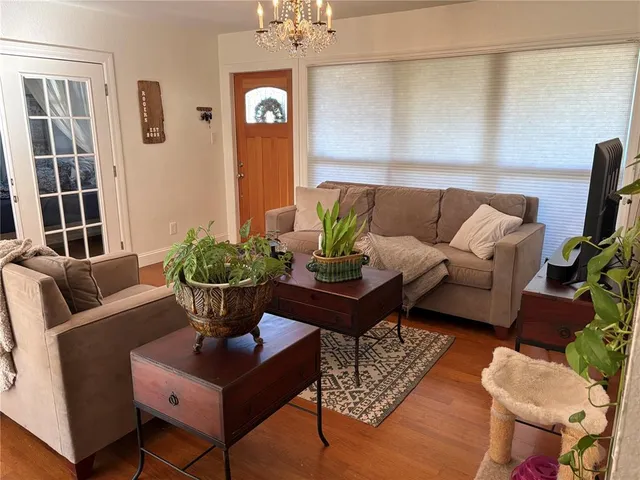 a living room with furniture potted plant and a window