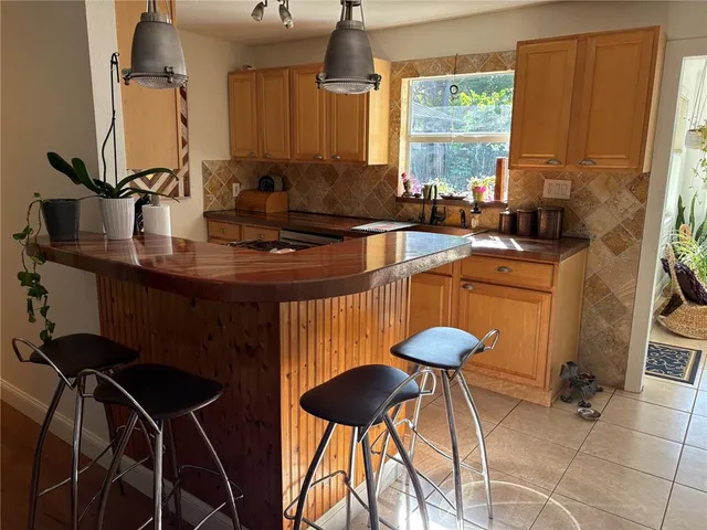 a kitchen with a table chairs and a sink