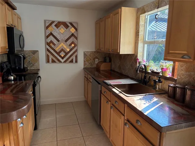 a kitchen with a sink and a stove top oven