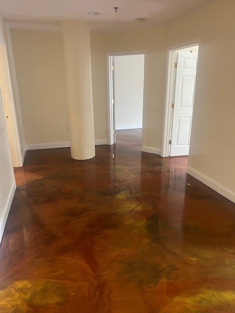 17 Federal Street, Unit 210 Worcester, MA 01608 - Photo 4 of 8 an empty room with wooden floor and windows