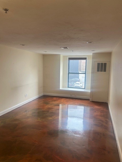 17 Federal Street, Unit 210 Worcester, MA 01608 - Photo 7 of 8 an empty room with wooden floor and windows