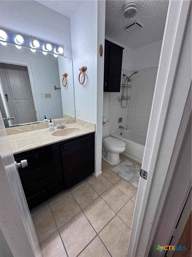 1301 North 10th Street Temple, TX 76501 - Photo 13 of 25 a spacious bathroom with a double vanity sink a toilet and a mirror