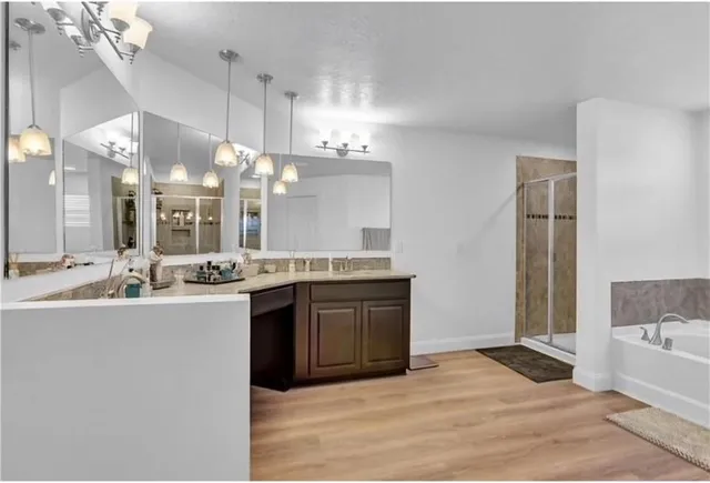 a large bathroom with a sink vanity granite and a large mirror