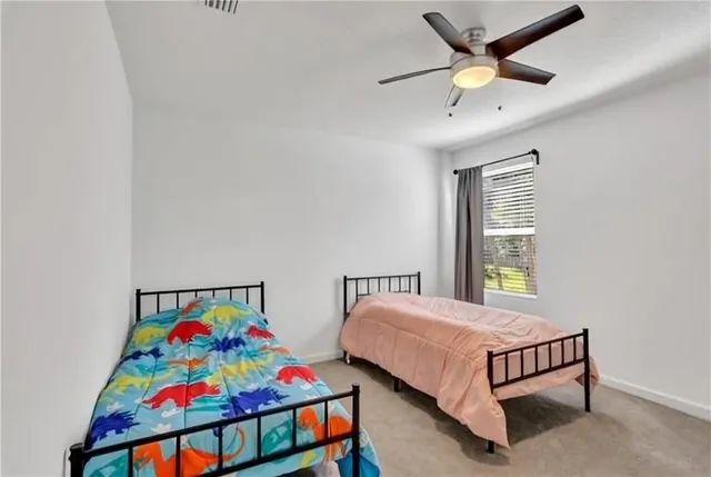 a bedroom with two beds and a window