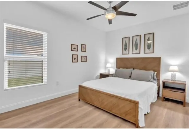 a bedroom with a bed and a window