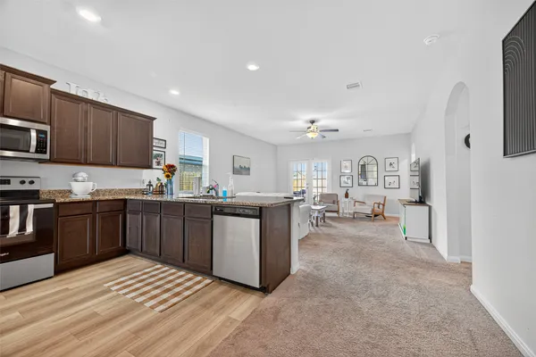 a kitchen with granite countertop wooden cabinets a stove top oven and granite counter tops