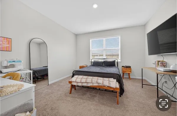 a bed room with a bed and a chair
