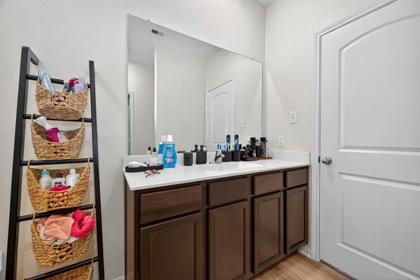 a bathroom with a bathtub sink vanity and mirror