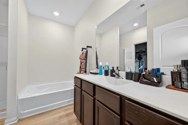 a view of walk in closet with clothes