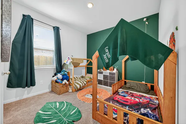 a bedroom with furniture and a wooden floor