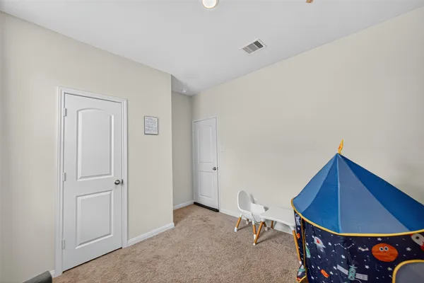 a living room with furniture a flat screen tv and a table