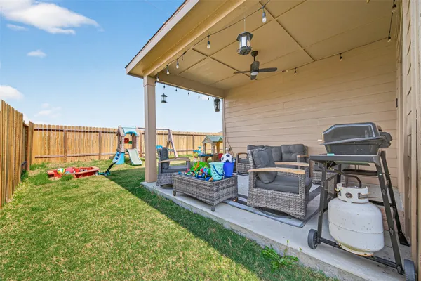 a view of a backyard with table and chairs
