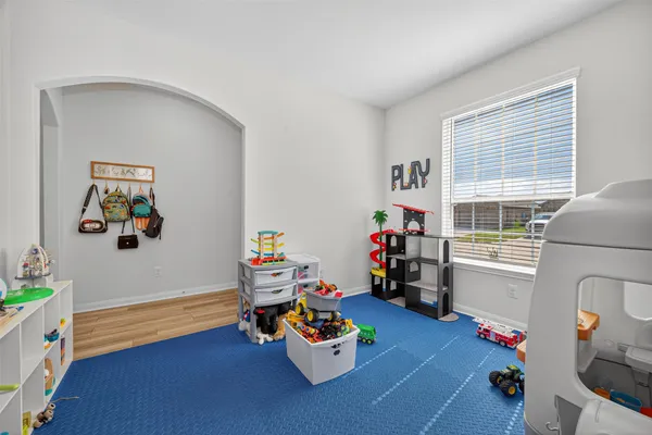 a room with toys and a wooden floor
