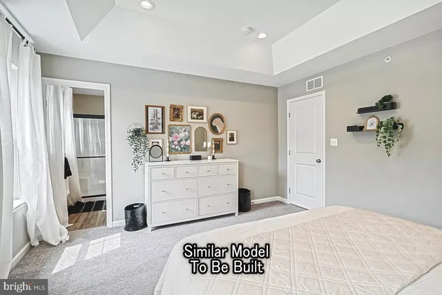 a bedroom with a bed and a dresser