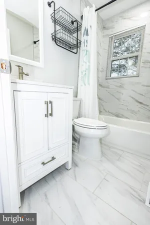 a bathroom with a toilet sink and shower