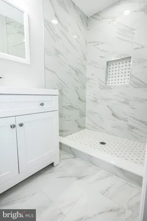 a bathroom with a bathtub and shower