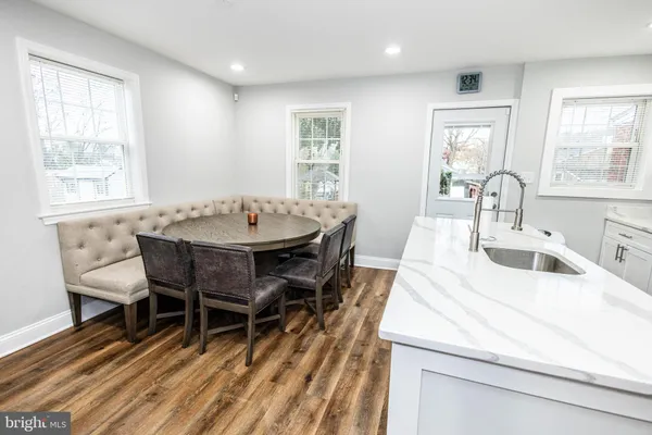 a dining room with furniture a rug and wooden floor