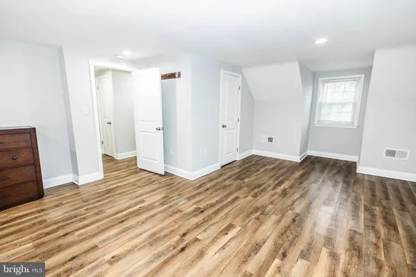 a view of a room with wooden floor and bathroom