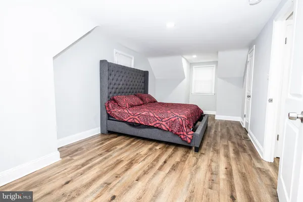 a bedroom with a bed and a night stand