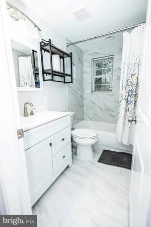 a bathroom with a sink toilet a mirror and shower