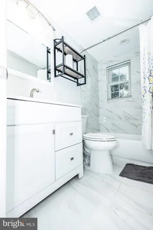 a bathroom with a sink a toilet and a bathtub