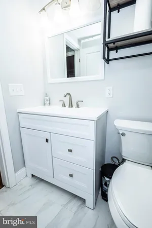 a bathroom with a toilet sink and mirror