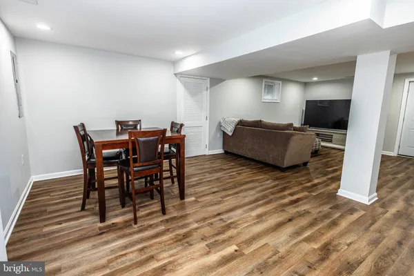 a dining room with furniture and wooden floor