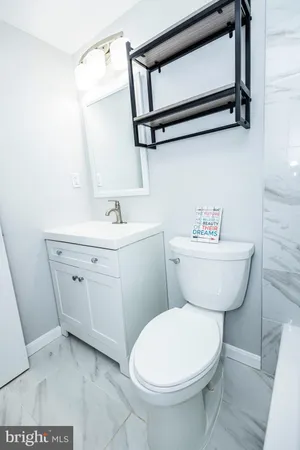 a bathroom with a toilet a sink and a mirror