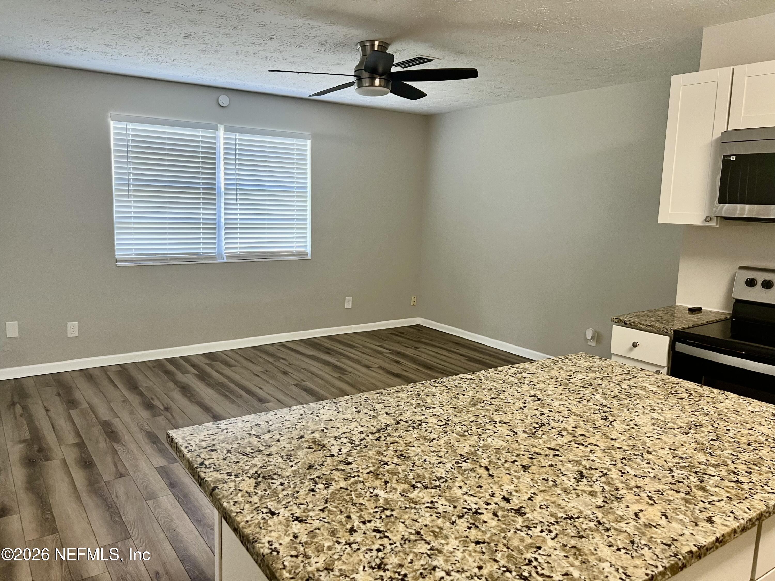 10964 Bacall Road West Jacksonville, FL 32218 - Photo 6 of 19 a bed sitting in a bedroom next to a window