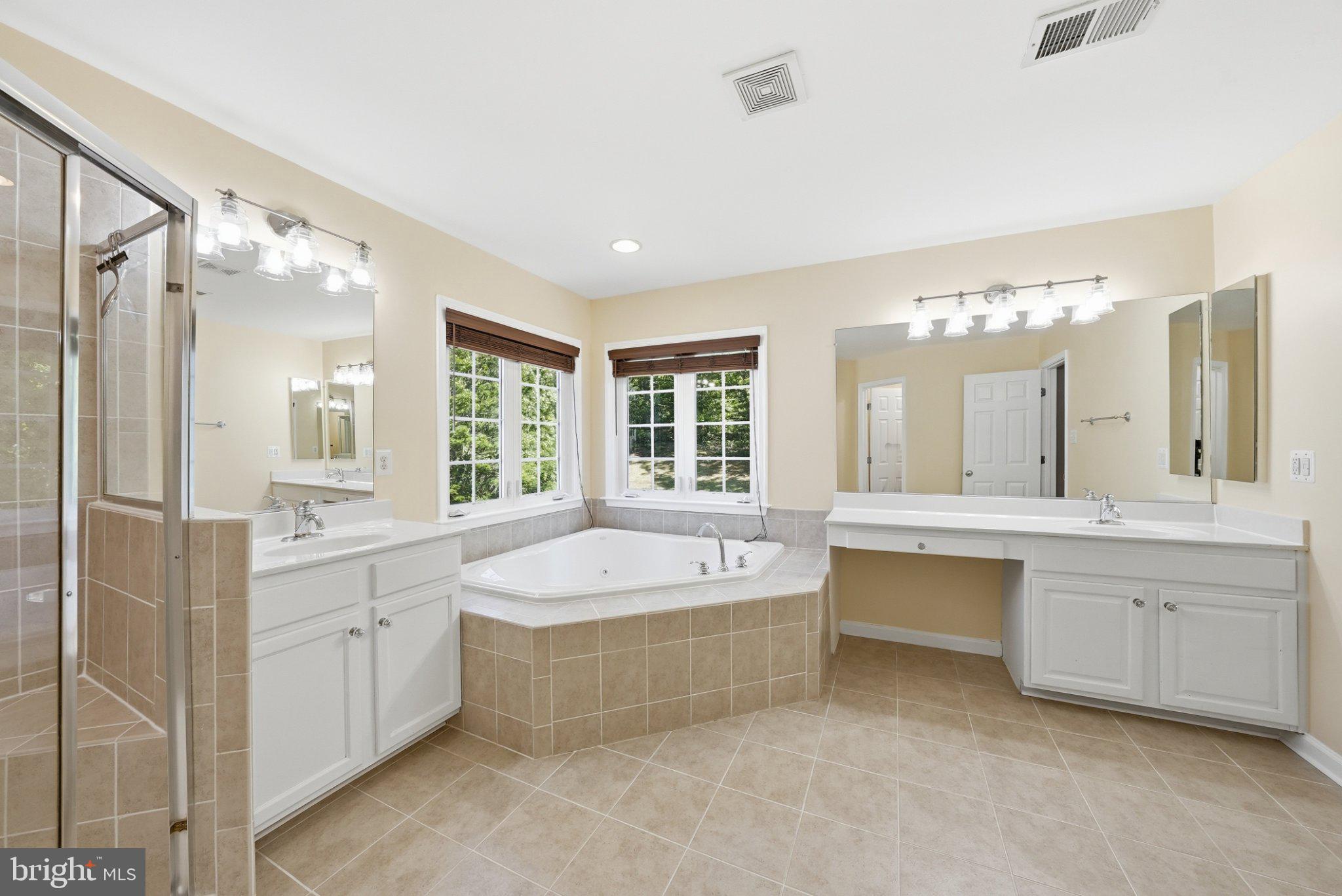 3679 Expedition Drive Triangle, VA 22172 - Photo 35 of 65 a spacious bathroom with a tub sink shower and mirror