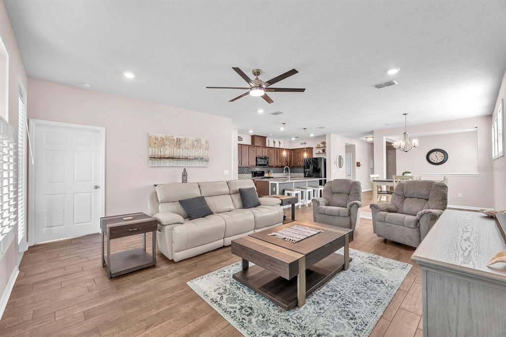 6230 Plover Meadow Street Lithia, FL 33547 - Photo 17 of 50 a living room with furniture a rug and a flat screen tv
