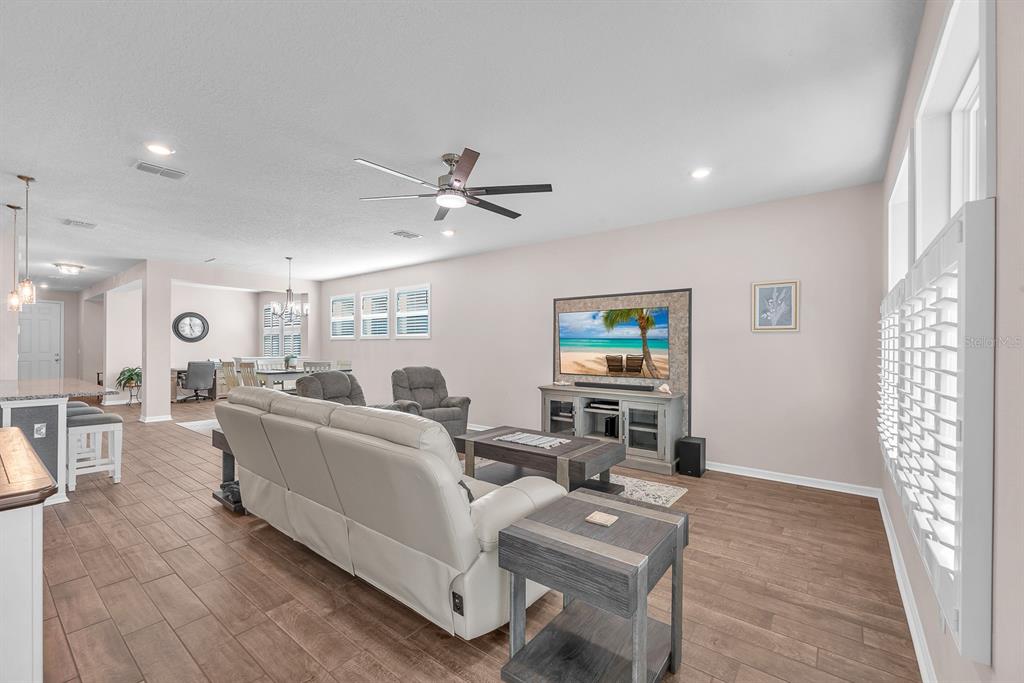6230 Plover Meadow Street Lithia, FL 33547 - Photo 19 of 50 a living room with furniture and a flat screen tv