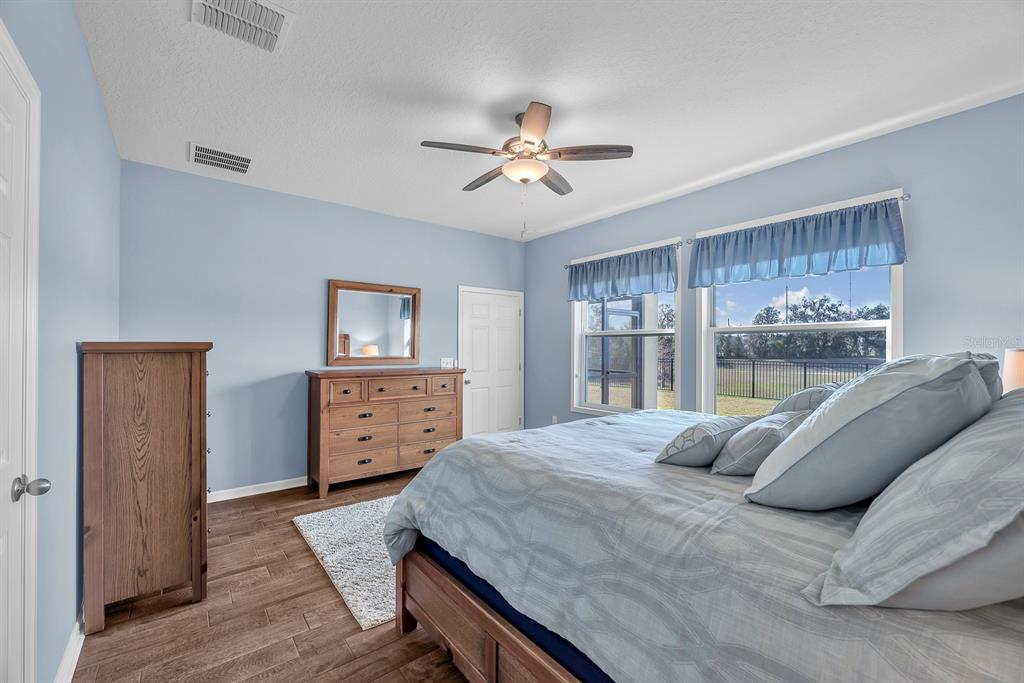 6230 Plover Meadow Street Lithia, FL 33547 - Photo 22 of 50 a bedroom with a bed a window and dresser