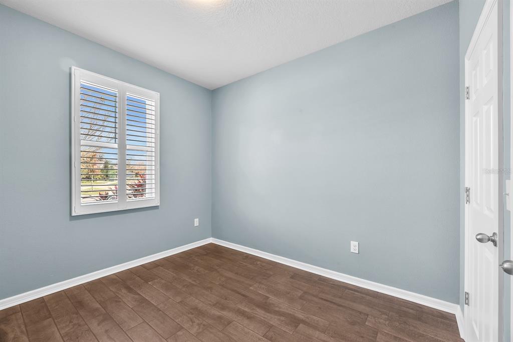 6230 Plover Meadow Street Lithia, FL 33547 - Photo 27 of 50 an empty room with wooden floor and windows