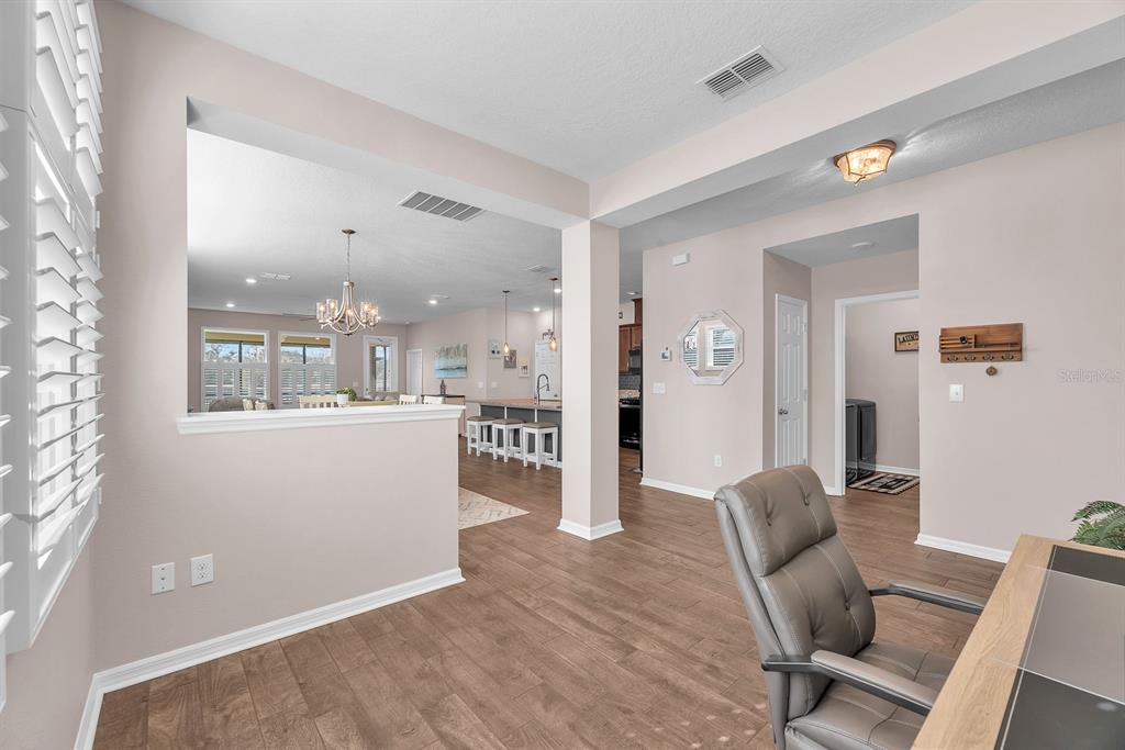 6230 Plover Meadow Street Lithia, FL 33547 - Photo 8 of 50 a living room with furniture and a view of kitchen