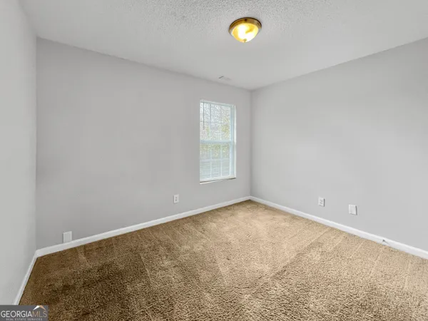 an empty room with a chandeliers