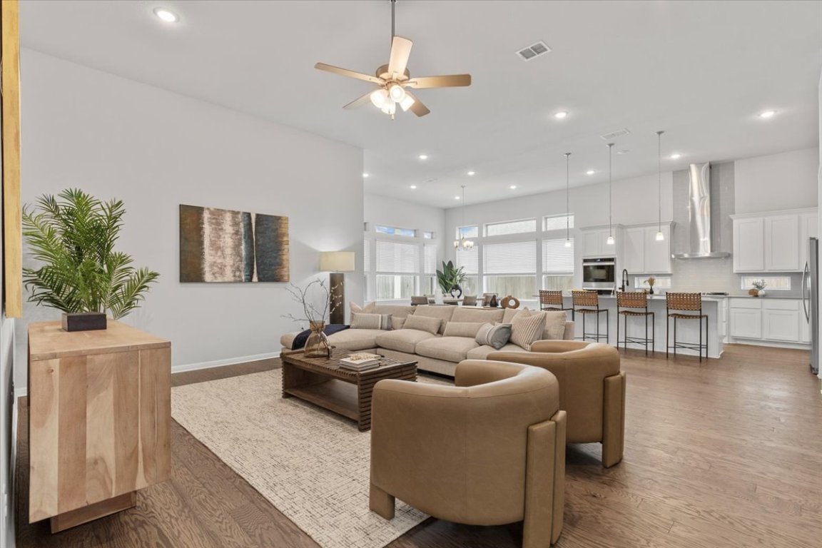 271 Eclipse Drive, Unit 67 Austin, TX 78737 - Photo 11 of 39 a living room with furniture kitchen view and a chandelier
