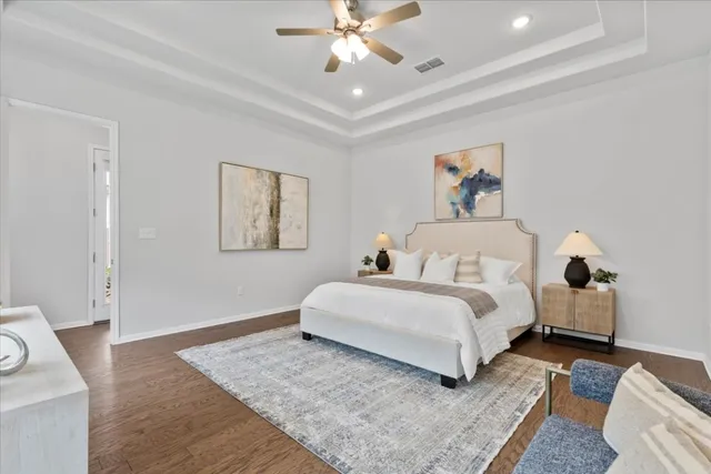 a spacious bedroom with a bed and a couch