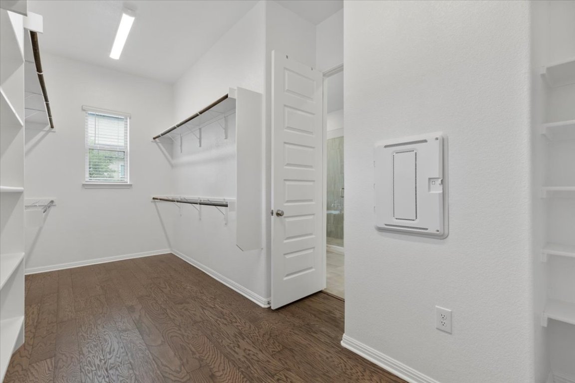 271 Eclipse Drive, Unit 67 Austin, TX 78737 - Photo 18 of 39 an empty room with wooden floor and white walls