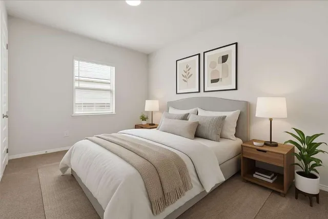 a bedroom with a bed and a potted plant