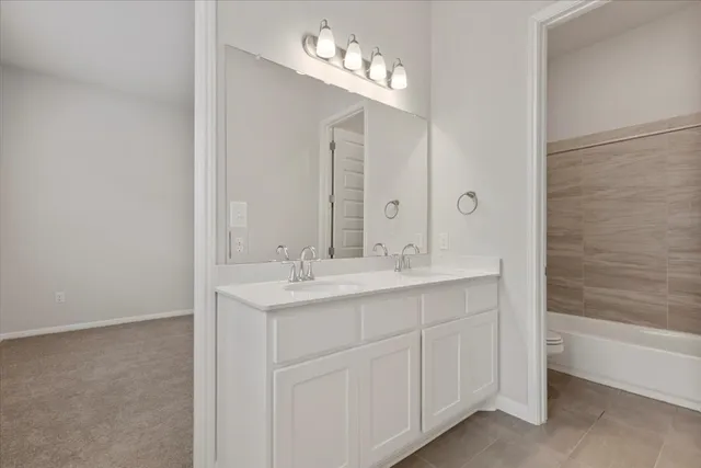 a bathroom with a double vanity sink and a mirror