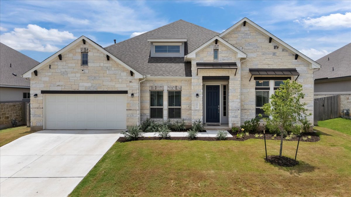 271 Eclipse Drive, Unit 67 Austin, TX 78737 - Photo 2 of 39 a front view of a house with a yard and potted plants